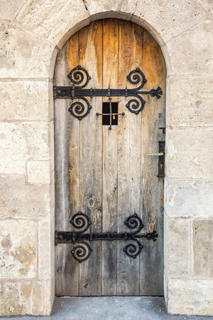 Door with bars on old wall on sunset at Budapest,hungaryの写真素材