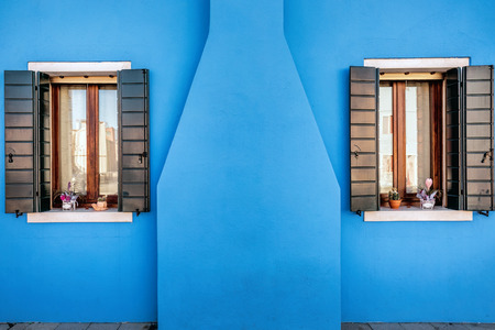 Blue chimney and windows of houses on the famous island Burano, Venice, Italyの写真素材