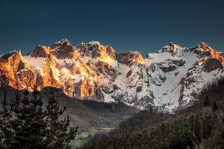 Sunrise over Peaks of Europe ridge with wooden fence, Cantabria,Spain.の写真素材