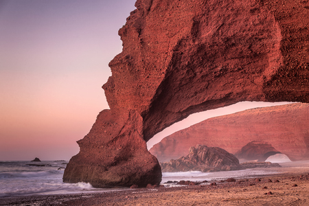 Sunset at red arches of Legzira beach, Sidi Ifni, Souss-Massa-Draa, Morocco.の写真素材