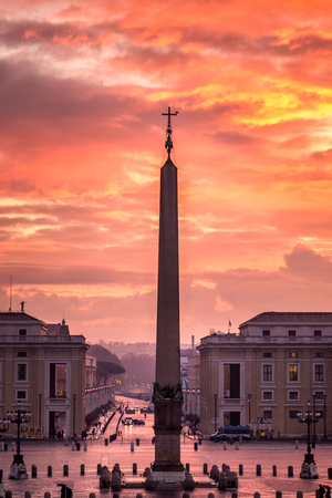 Sunrise over the St. Peters Basilica in Vatican City. Morning at the most famous landmark, empty of people street, cloudy sky.の写真素材