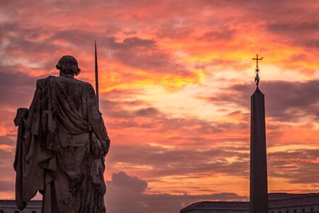 Sunrise over the St. Peters Basilica in Vatican City. Morning at the most famous landmark, empty of people street, cloudy sky.の写真素材