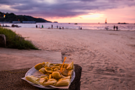 Banana pancake with amazing sunset over the sea at Phuket, Thailand.の写真素材