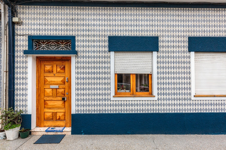 Colorful wooden door in the facade of a typical Portuguese house at Porto, Portugal.の写真素材
