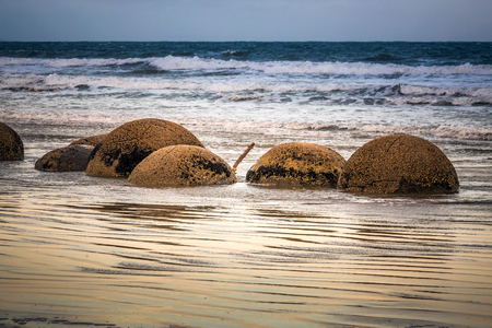 Unreal spheric Moeraki Boulders at sunset, Koekohe beach, Otago, South Island, New Zealand.の写真素材