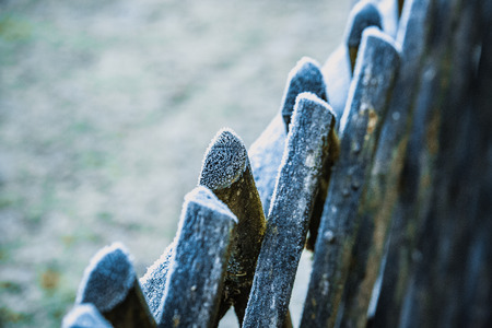 Wooden fence covered with snow somewhere in the countryside on a winter morningの写真素材