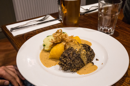 Very delicious dinner in scottish restaurant, on a plate potato with meatball in sauceの写真素材