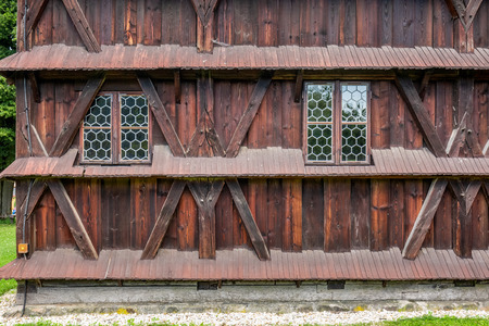 Wood door and windows with wooden shutters on peach colored wall at Warsaw, Poland.の写真素材