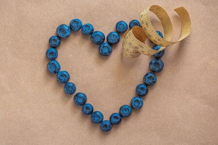 Blueberries in the shape of heart as a symbol of Valentine and love at natural background. Shot with...