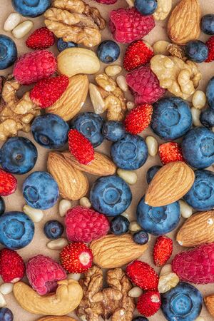 Close up shot of fresh variety of wild berries and nuts, healthy lifestyle .の写真素材
