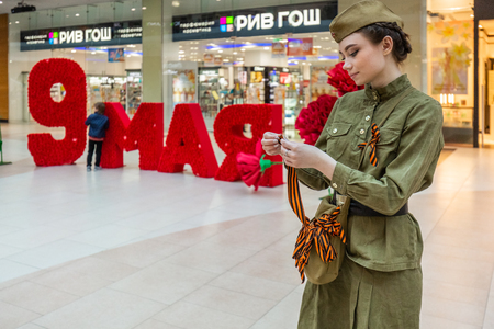 Girl dresset in soviet uniform on victory day.のeditorial素材