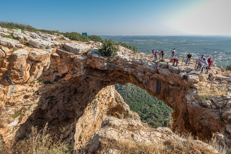 Acre, Israel - April 15 2018: Tourist rock climber climbs up the rock overcoming obstacles on a dangerous rock site in the north of Israelのeditorial素材