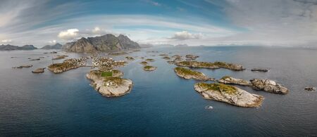 Incredible aerial view of Henningsvaer, its scenic football field and mountains in the background. A small fishing village located on several small islands in the Henningsvaer, Lofoten Islands, Norwayの写真素材