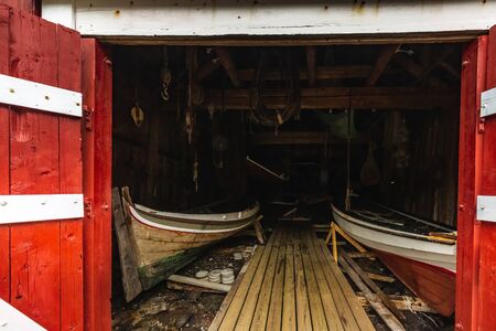 Traditional red wooden houses, rorbuer in the small fishing village of Nusfjord, Lofoten islands, Norway.の写真素材