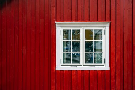 Window of traditional red wooden houses, rorbuer in the small fishing village of Nusfjord, Lofoten...