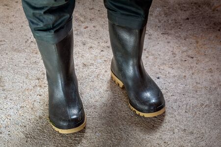 Fisherman old rubber waterproof boots for fishing.