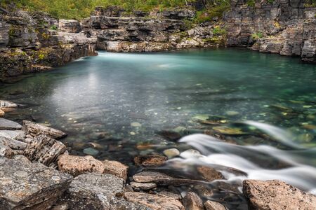 Cloudy fall autumn view of Abisko National Park, Kiruna Municipality, Lapland, Norrbotten County, Sweden, with Abiskojokk river and Nuolja mountain, near border of Finland, Sweden and Norwayの写真素材