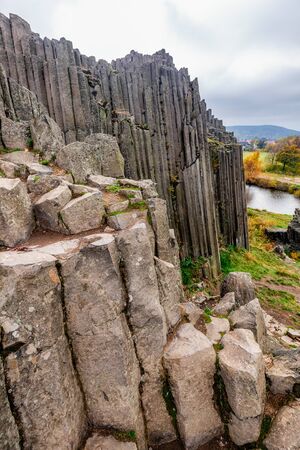 View of the polygonal structures of basalt columns, also named Herrnhausfelsen, natural monument...
