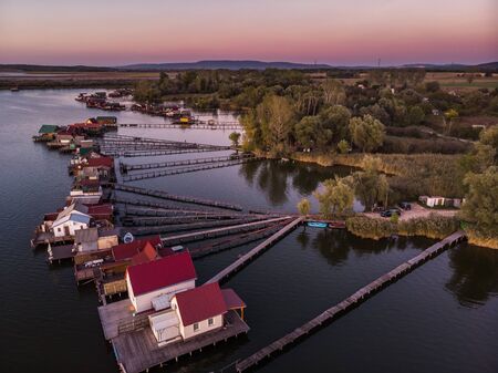 Floating village Bokodi to in Hungary at sunset. These houses belong to local fishermen.の写真素材