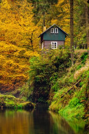 River with autumn leaves and hut on the river Kamenice in Bohemian Switzerland. Near the Wild Gorge.の写真素材