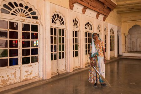 Jodhpur, India - March 07 2017: A woman cleans the grounds to the museums of Fort Mehrangarh. She does her job in a good mood.のeditorial素材