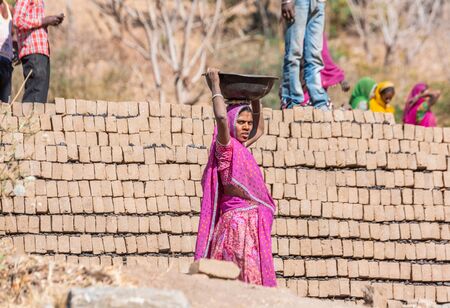 Udaipur, India - March 06 2017: Local woman working on brick making factory.