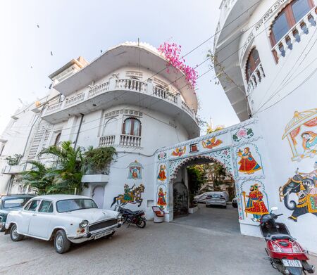 Udaipur, India - March 04 2017: White house with a huge hand drawings on the walls.