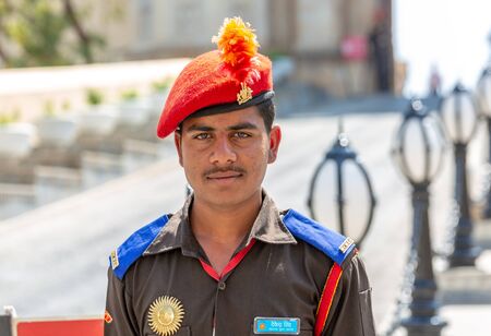 Udaipur, India - March 04 2017: Man working at the City Palace Museum. A man is glad to all visitors.のeditorial素材