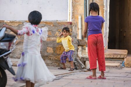 Jaisalmer, India - March 10 2017: Three young children playing with a ball in the street.のeditorial素材