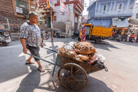 Jodhpur, India - March 07 2017: Man takes garbage in the cart.のeditorial素材