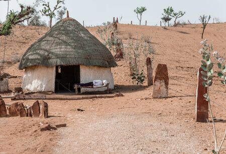 Jodhpur, India - March 08 2017: House for a family living in the village. Old man with a beard on a bed.のeditorial素材