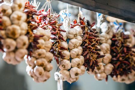 Whole white garlic heads and hot peppers on a food market in Budapest, Hungary.の写真素材