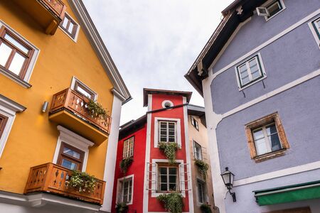 Colorful houses at picture-postcard view of famous Hallstatt mountain village in the Austrian Alps at beautiful light in autumn at Hallstatt, Austria.の写真素材