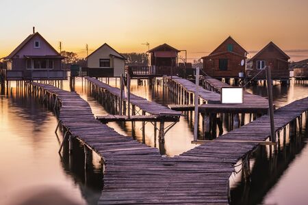 Floating village Bokodi to in Hungary at sunset. These houses belong to local fishermen.の写真素材