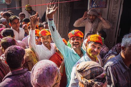 Vrindavan, India - March 12 2017: Indian people covered in different colours celebrating Holi...