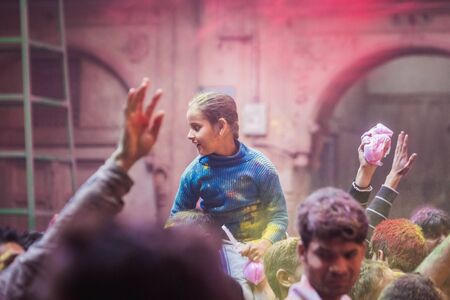 Vrindavan, India - March 12 2017: Indian people covered in different colours celebrating Holi festival in Vrindavan, India.のeditorial素材