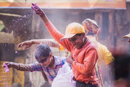 Vrindavan, India - March 12 2017: Indian people covered in different colours celebrating Holi...
