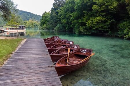 Wooden boats near waterfalls of one of the most astonishing places in the world at  Plitvice Lakes, Croatia. A truly virgin and wonderful piece of nature.の写真素材