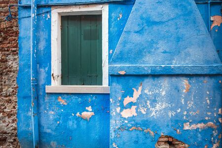 Picturesque wall with windows with shutters at the famous island Burano, Venice, Italy.の写真素材