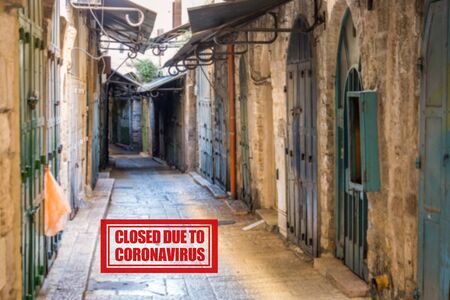 The empty street with closed shops in the Old City of Jerusalem. Following the coronavirus outbreak, the Israeli Government has decided for a massive curfew, leaving the Old Town totally deserted.の写真素材