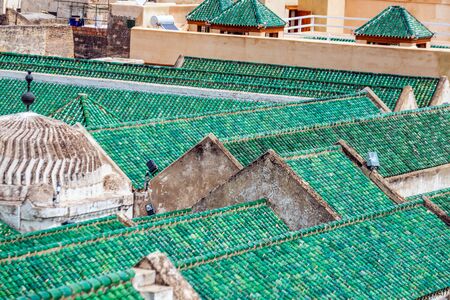 Cityscape View over the rooftops with green tiles of largest medina in Fes, Morocco, Africa. Maghreb, exterior.の写真素材