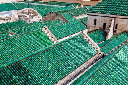 Cityscape View over the rooftops with green tiles of largest medina in Fes, Morocco, Africa....