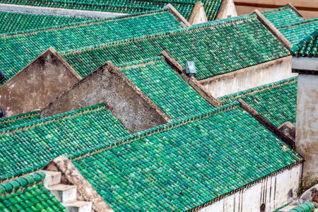 Cityscape View over the rooftops with green tiles of largest medina in Fes, Morocco, Africa....