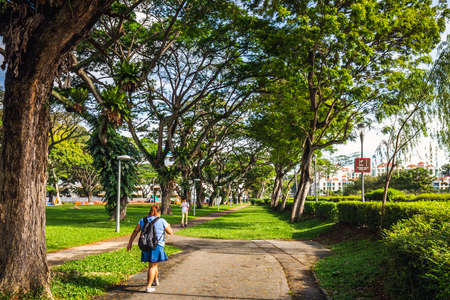 Girl walks in the park at Singapore, Singapore - March 31 2017.のeditorial素材
