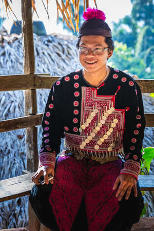 Local man in costume at famous long neck tribe village in Chiang Mai, Thailand. Chiang Mai, Thailand - November 05 2017.のeditorial素材