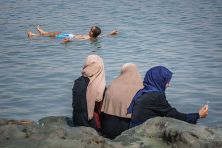 Tourist swim in Dead Sea. Body care treatment in Israel. Dead Sea, Israel - April 19 2018のeditorial素材