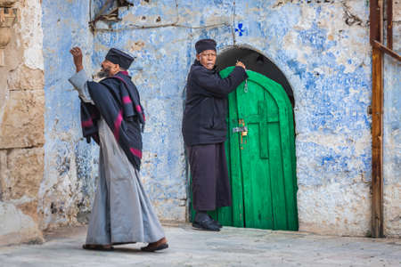 Ethiopian Orthodox priests at the church at the Ethiopian section of the Holy Sepulcher in Jerusalem. Jerusalem, Israel - April 19 2018のeditorial素材