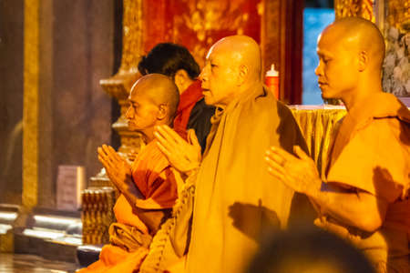 Monks at golden temple Wat Phra Doi Suthep shot at blue hour in Chiang Mai, Thailand. Chiang Mai,...