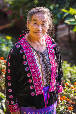Local elderly woman in costume at famous long neck tribe village in Chiang Mai, Thailand. Chiang Mai, Thailand - November 05 2017.のeditorial素材