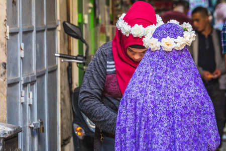 Muslim woman in The Old City market situated between the Jewish Quarter and the Muslim Quarter. Souvenir shops in Jerusalem. Jerusalem, Israel - April 19 2018のeditorial素材